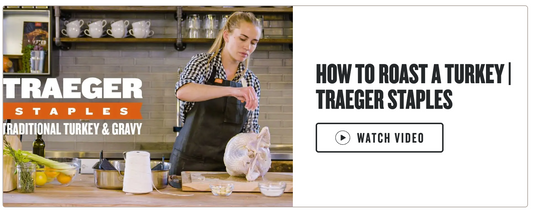 Person in apron preparing a turkey with Traeger  branding.